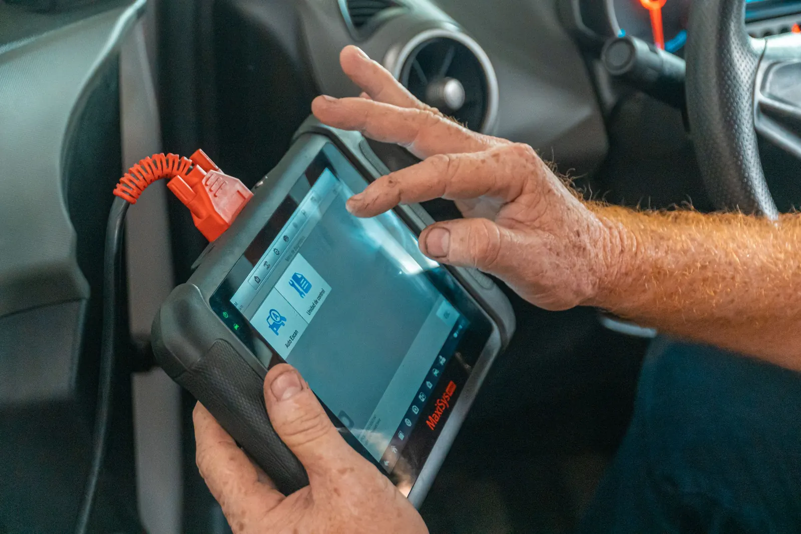 Diagnostic scanner plugged into a vehicle