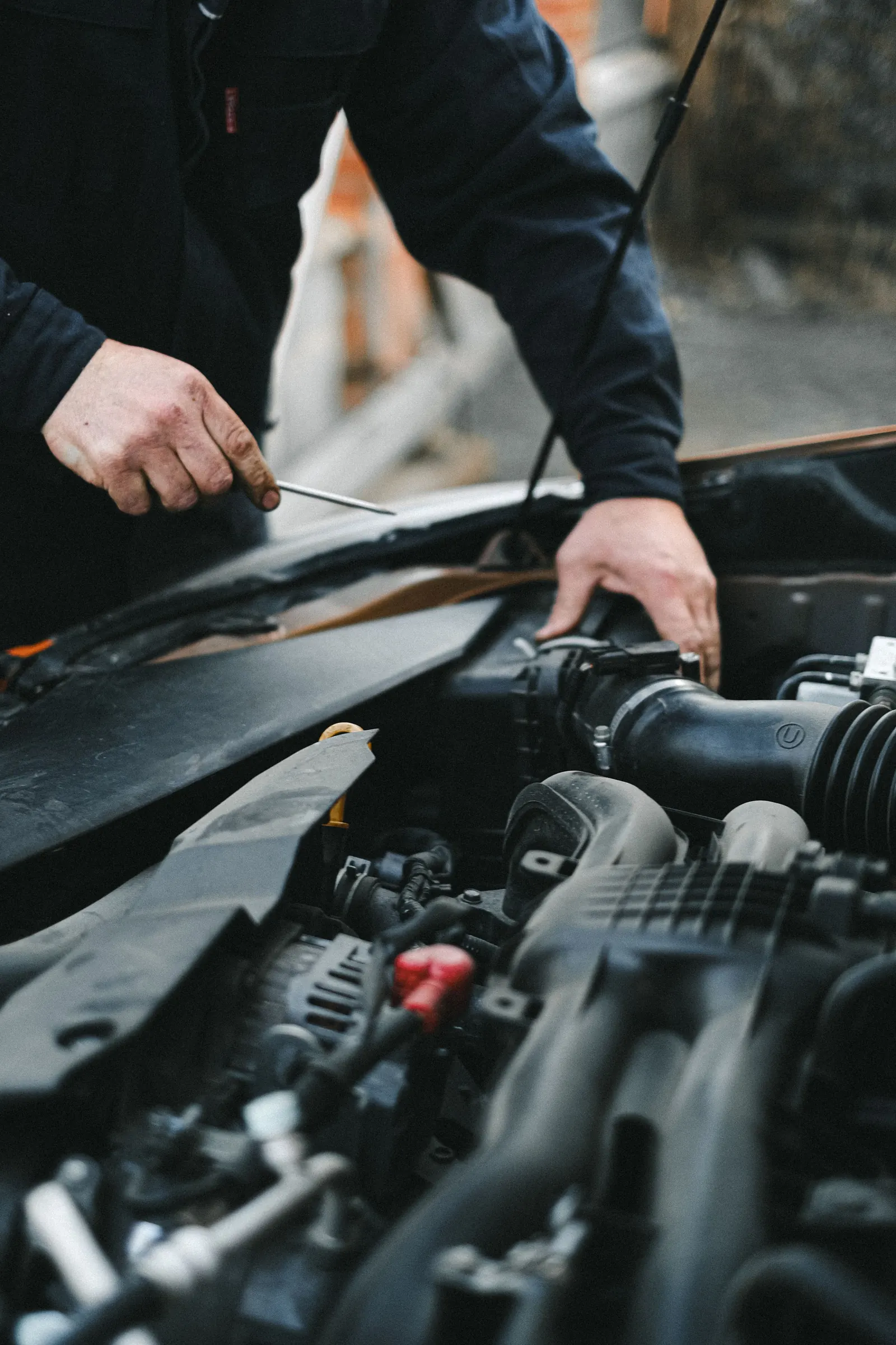 A technician servicing an engine